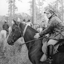 A graphite drawing of a woman on a horse at a Bird Dog Field Trial.