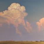 An original oil painting of thunder clouds over a rural Iowa landscape at sunset.